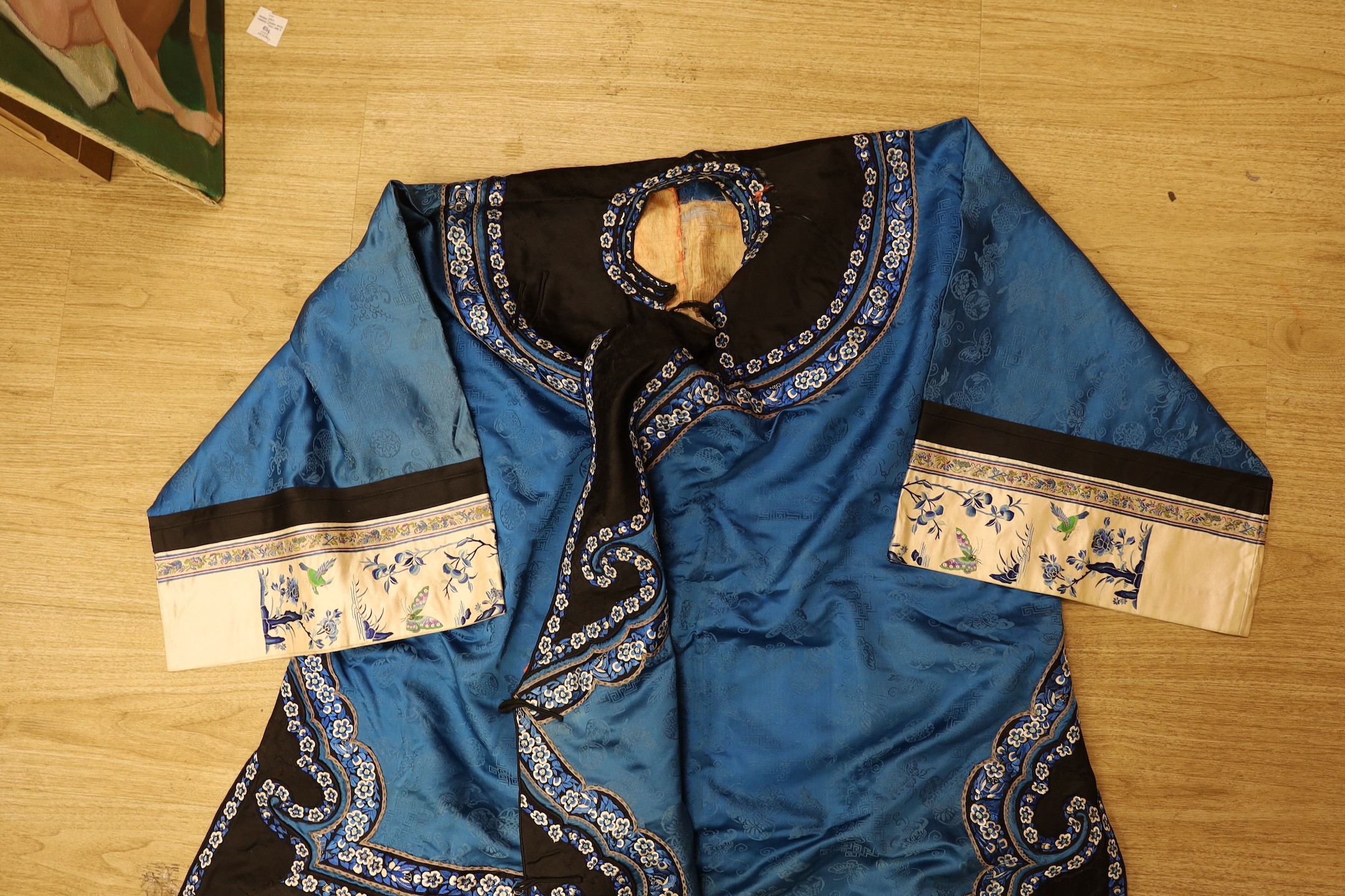 A Chinese silk robe, a 19th century patchwork panel and a panel from a Paisley summer shawl and a black parasol